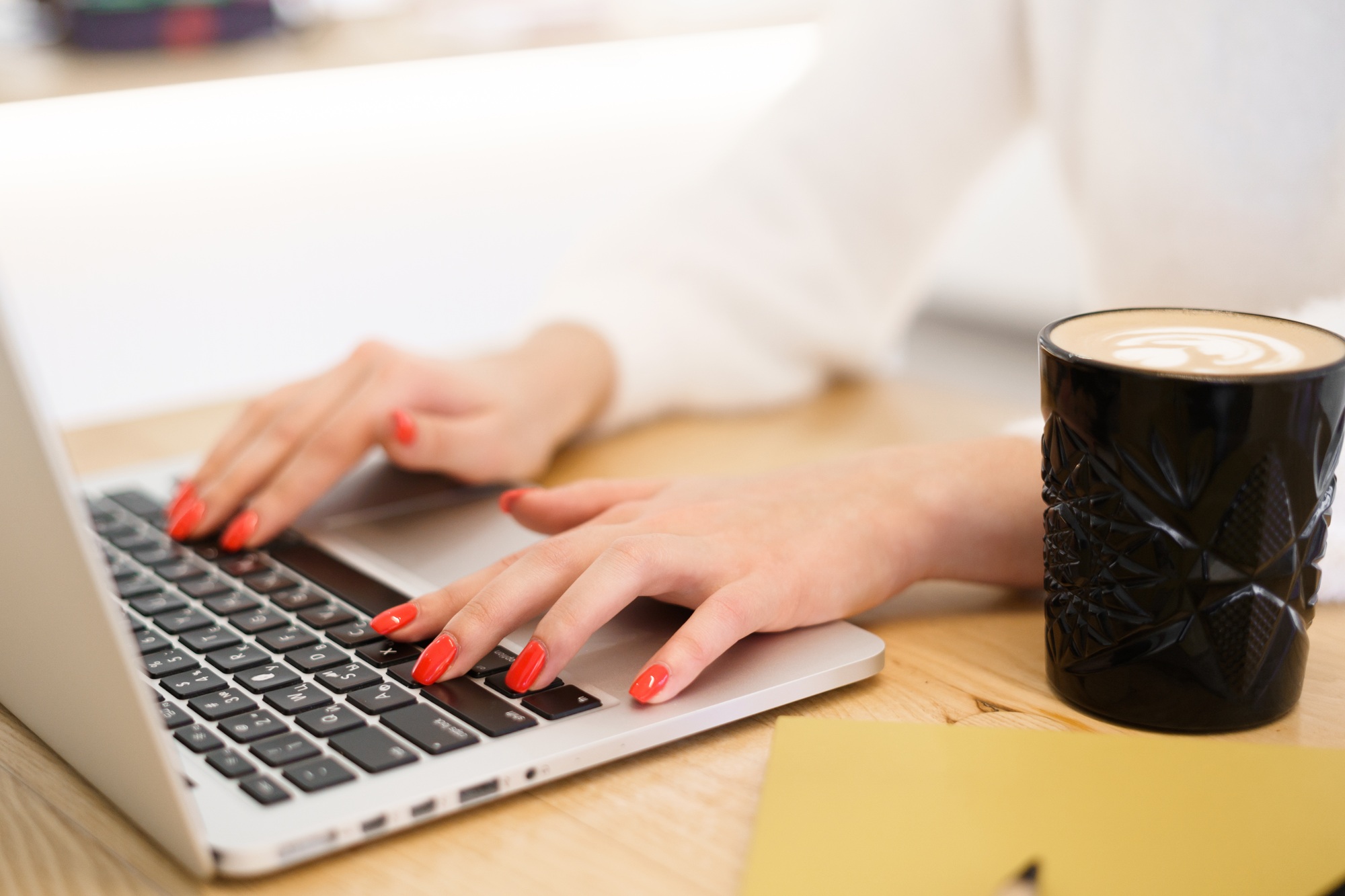 Woman hands typing on a laptop